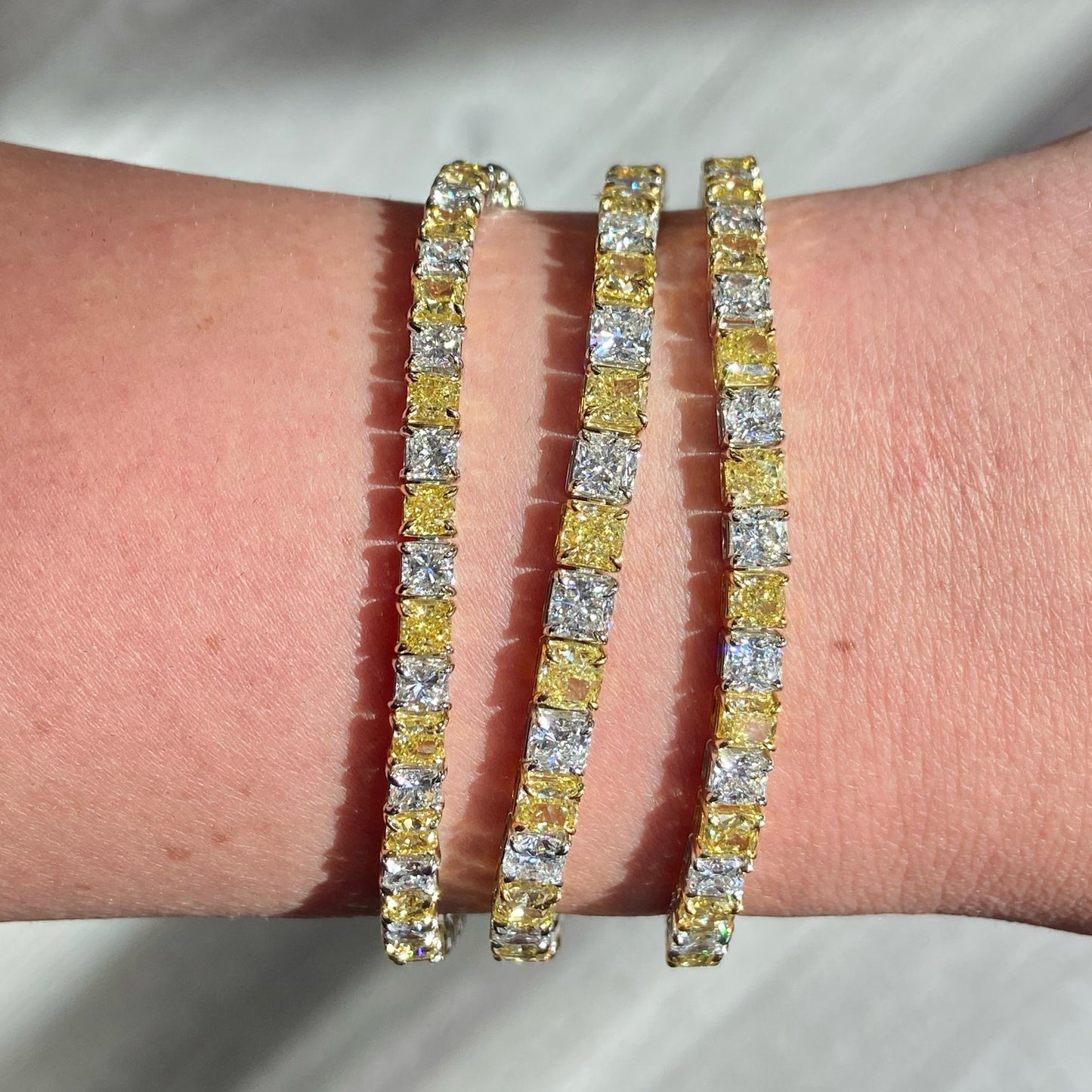 Alternating yellow and white diamond bracelet. tennis bracelet. alternating diamond bracelet. yellow diamond cushions. 