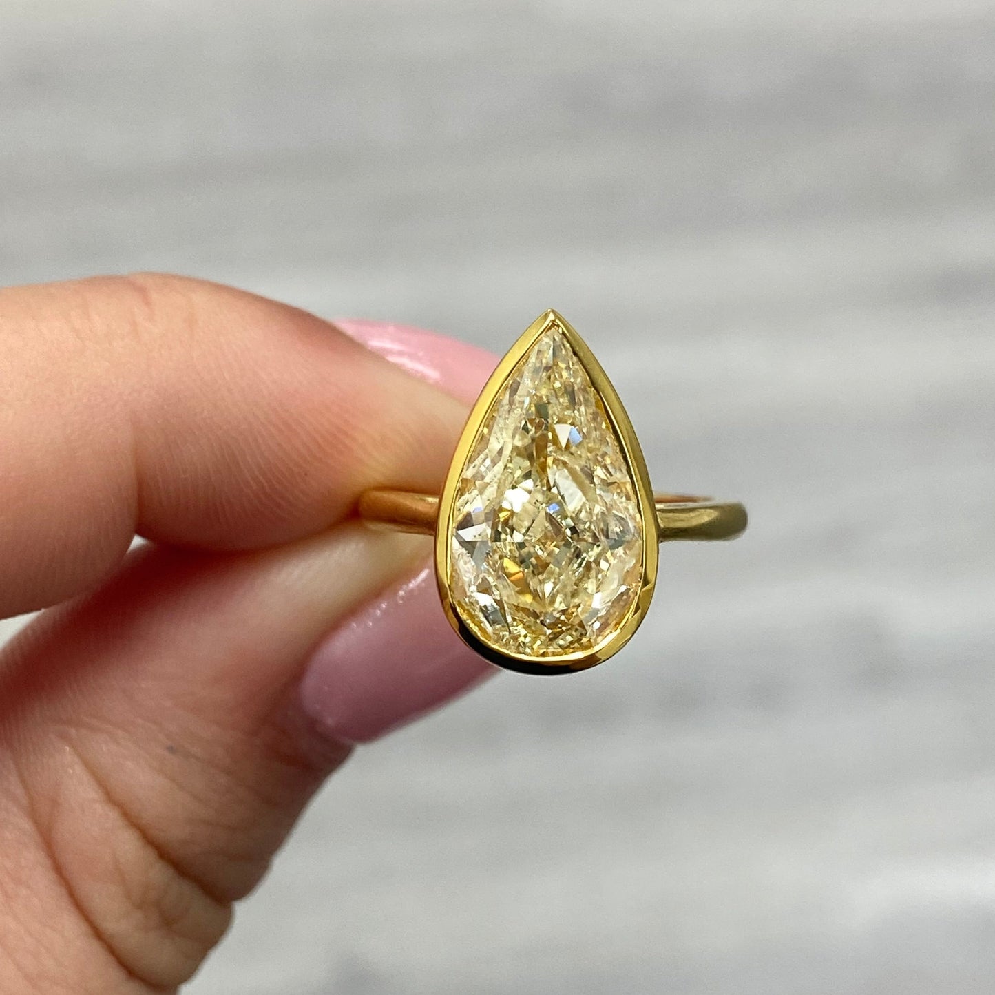 Bezel set diamond ring. Bezel engagement ring. 5 carat ring. Pear shape diamond ring